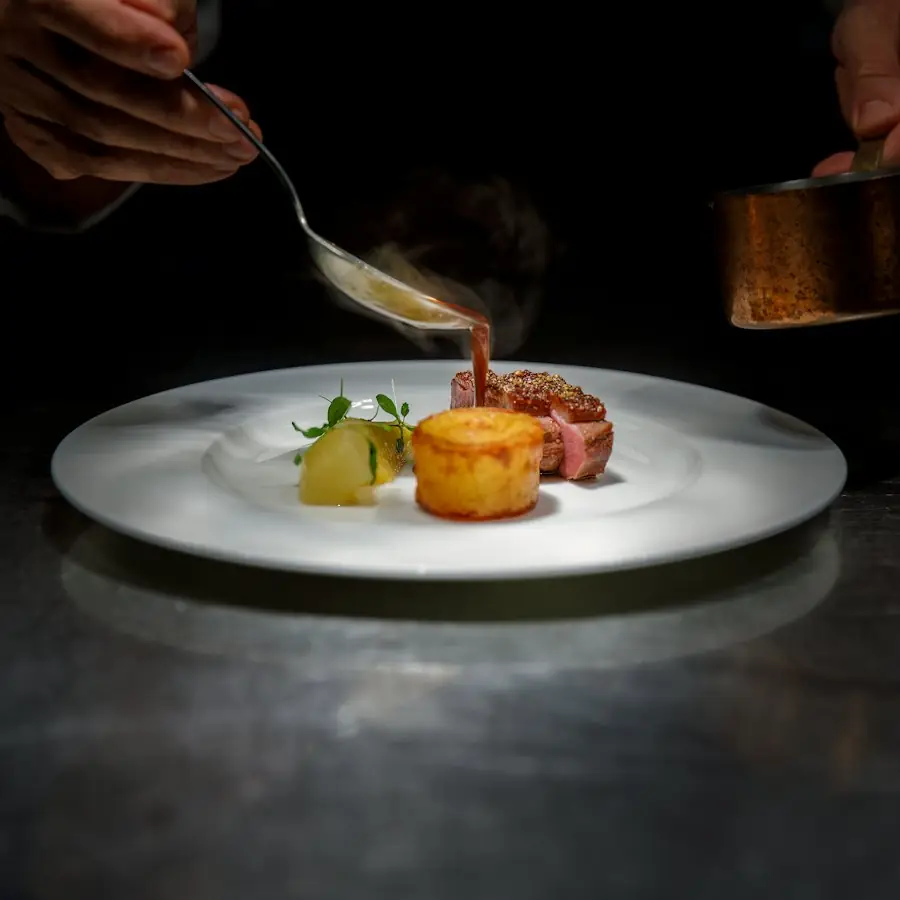 Chef plating a fine-dining dish